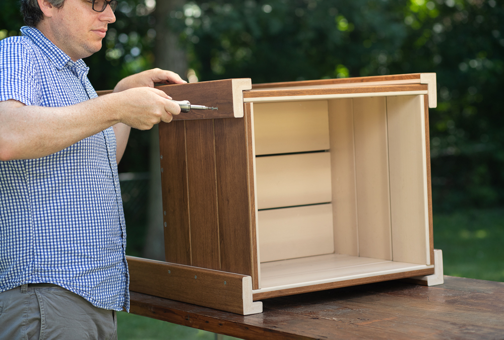 man putting together wood project