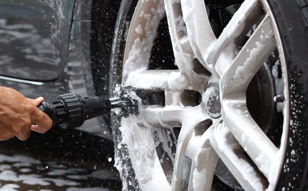 tire hubcap being washed with brush