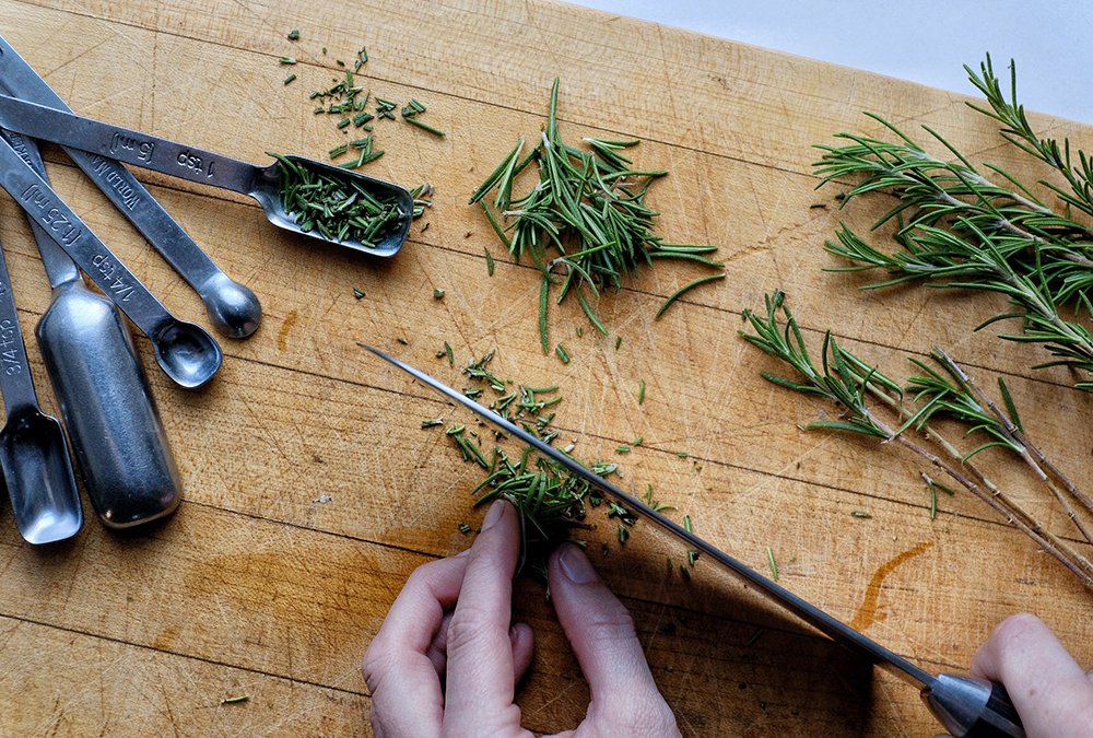 chopping herbs on cutting board