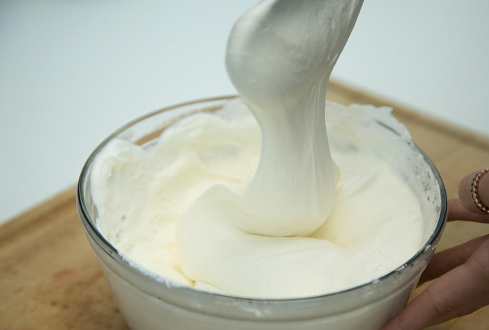 whipped cream in bowl with spoon