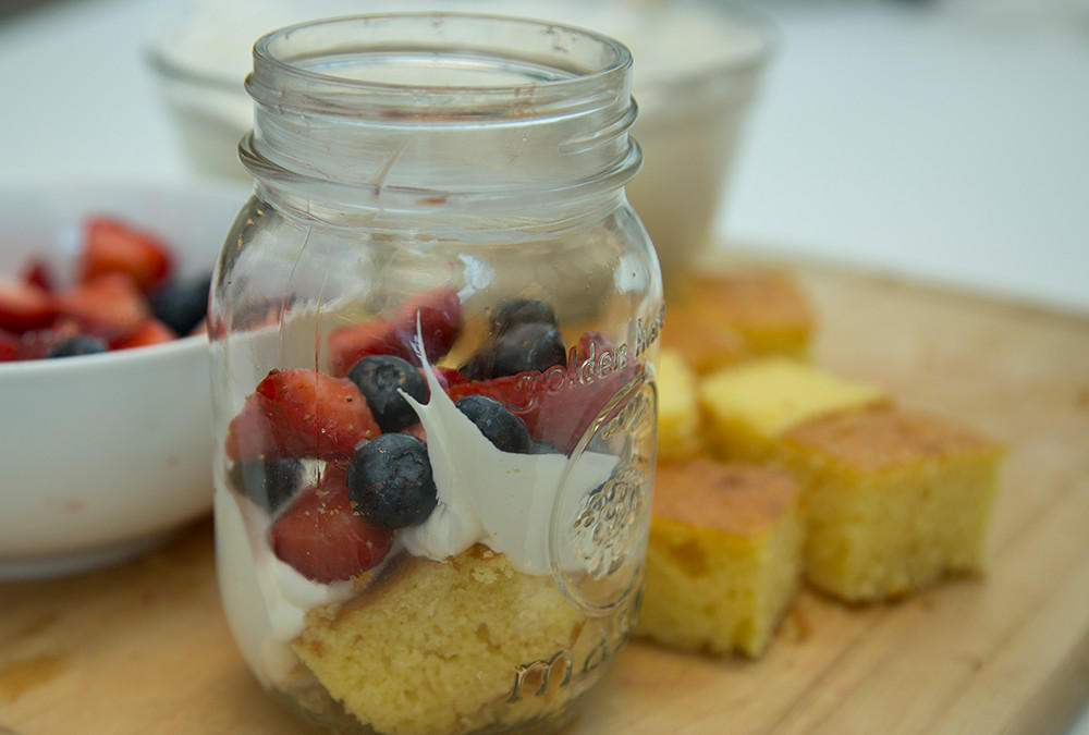 fruit on top of whipped cream in jar