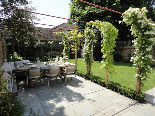 dining table with flowering vines above