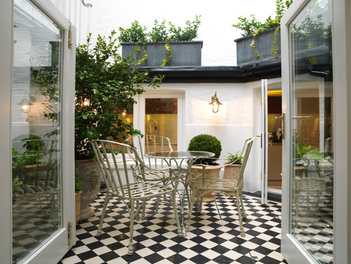 black and white tiled patio with dining table