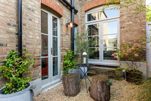 gravel terrace with plants and stumps