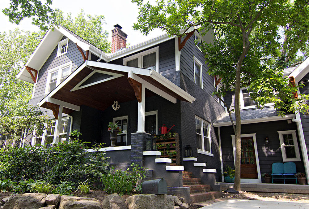 Navy blue house with white and wood accent