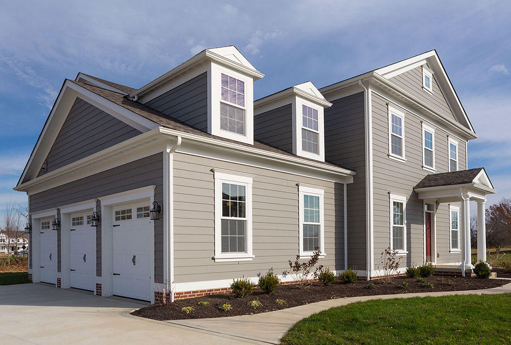 Grey house with white 3 car garage