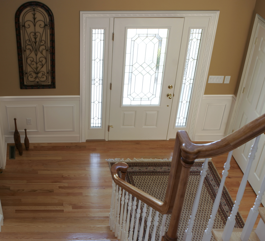 foyer from staircase brown walls white moulding