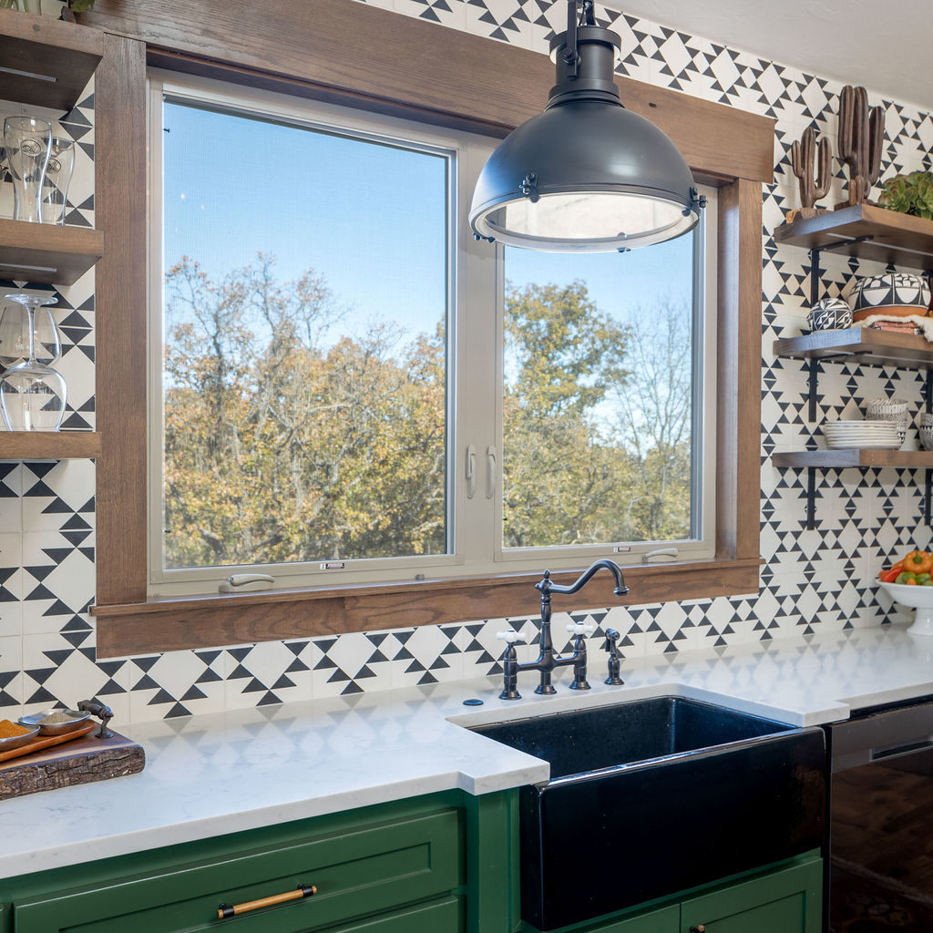 kitchen sink large window black and white tile green cabinets