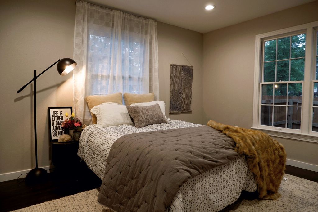 bedroom with lamp on gray bedding