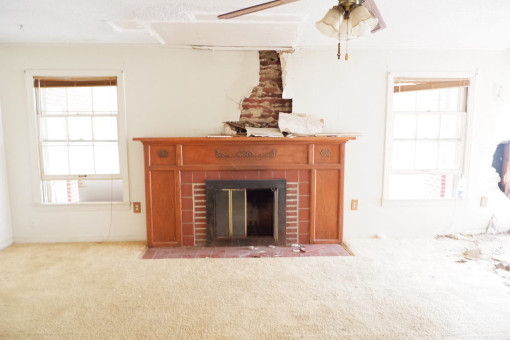 living room with fireplace before renovation