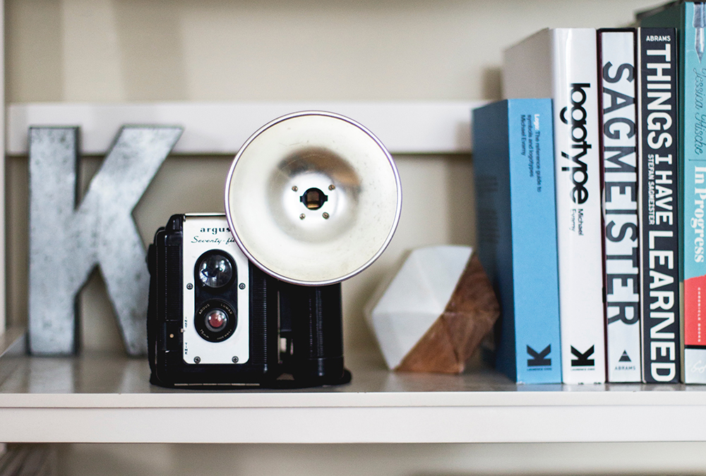 camera and books on shelf